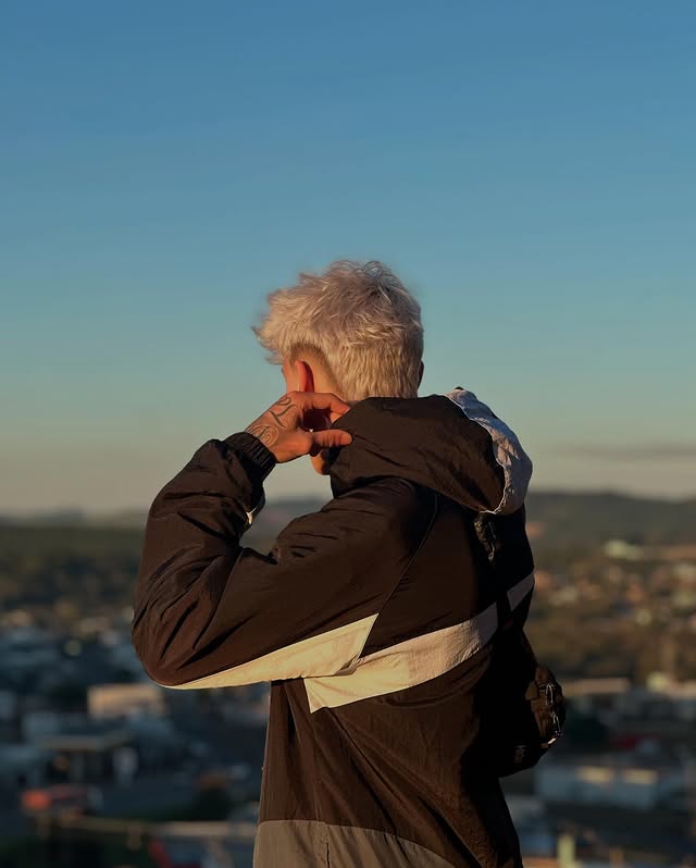 Visual masculino com cabelo platinado e estilo urbano